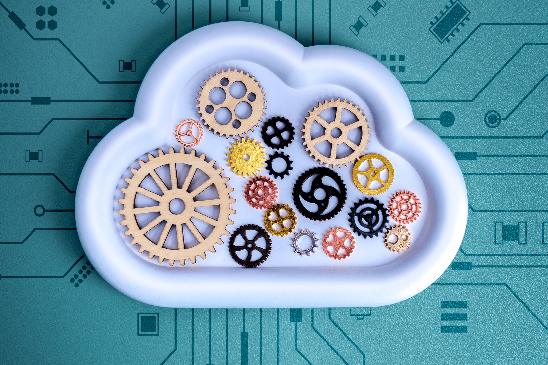 Cloud computing concept with gears inside a cloud over a circuit board background